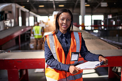 Buy stock photo Portrait of a warehouse manager holding a clipboard with workers in the background