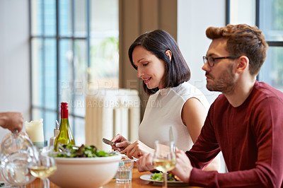 Buy stock photo Sho tofa young couple listening to conversation over dinner at home