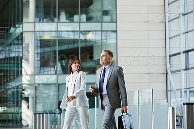 Buy stock photo Shot of businesspeople walking through the lobby of an office building