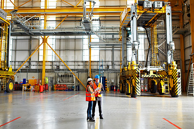 Buy stock photo Shot of two dock workers standing in a dockyard