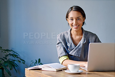 Buy stock photo Portrait of a young woman working on a laptop in an office