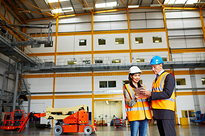 Buy stock photo Shot of two dock workers standing in a dockyard