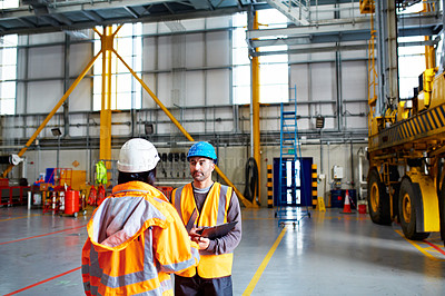 Buy stock photo Shot of two dock workers standing in a dockyard
