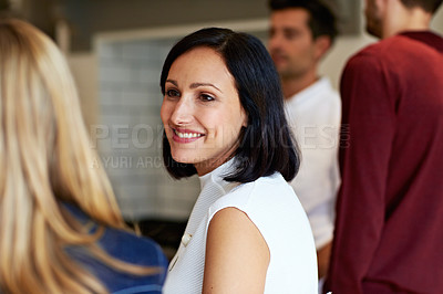 Buy stock photo Shot of a group of friends talking together while preparing dinner in the kitchen