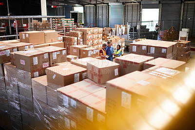 Buy stock photo Shot of people at work in a large warehouse full of boxes