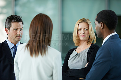 Buy stock photo Shot of businesspeople talking together in the lobby of an office building