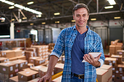 Buy stock photo Portrait of a worker holding a digital tablet while standing in a large warehouse