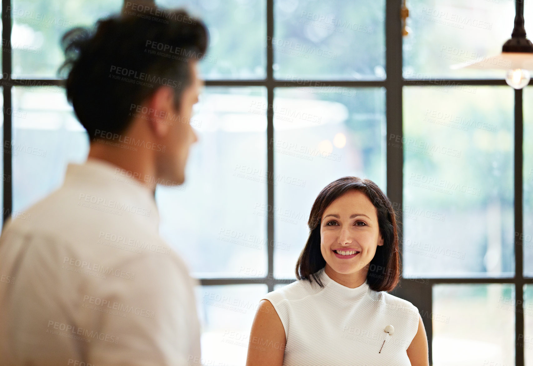 Buy stock photo Shot of a young couple talking together in their kitchen
