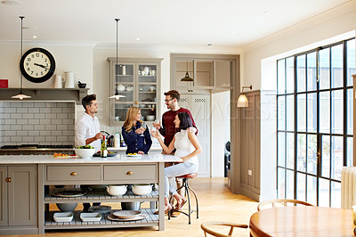 Buy stock photo Shot of two couples talking and toasting together while enjoying a get-together at home