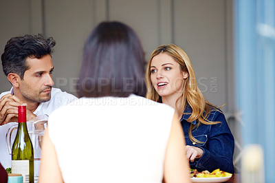 Buy stock photo Shot of a group of friends enjoying a home-cooked dinner together