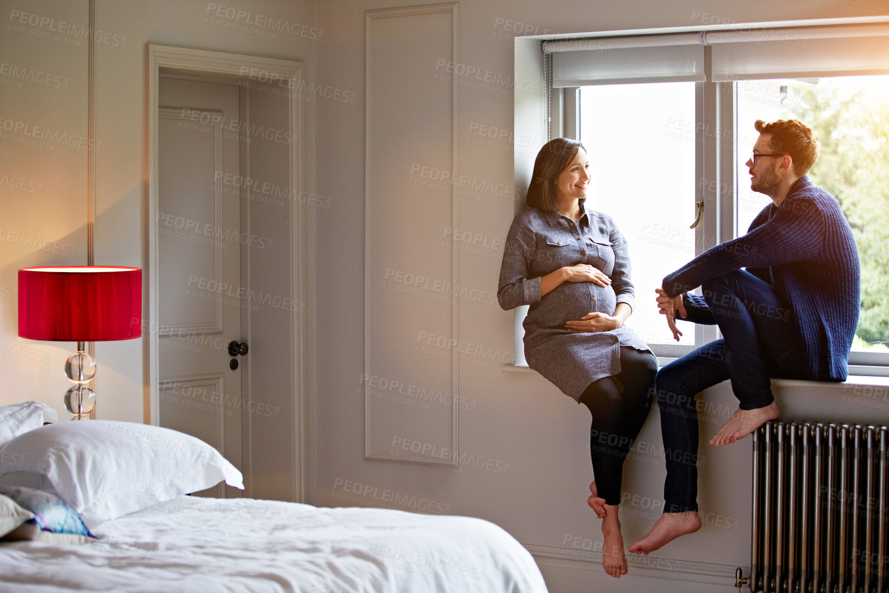 Buy stock photo Happy, pregnancy and wife with husband in bedroom of home together for bonding, support or wellness. Baby bump, talking and pregnant woman with man in apartment for development, love or security