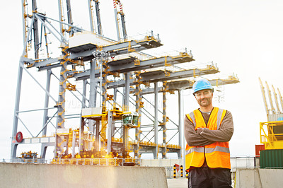 Buy stock photo Portrait of a young man in workwear standing outside on a large commercial dock