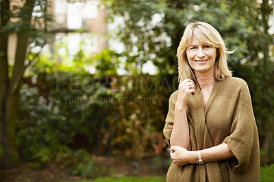 Buy stock photo Portrait of a mature woman standing outside in her yard