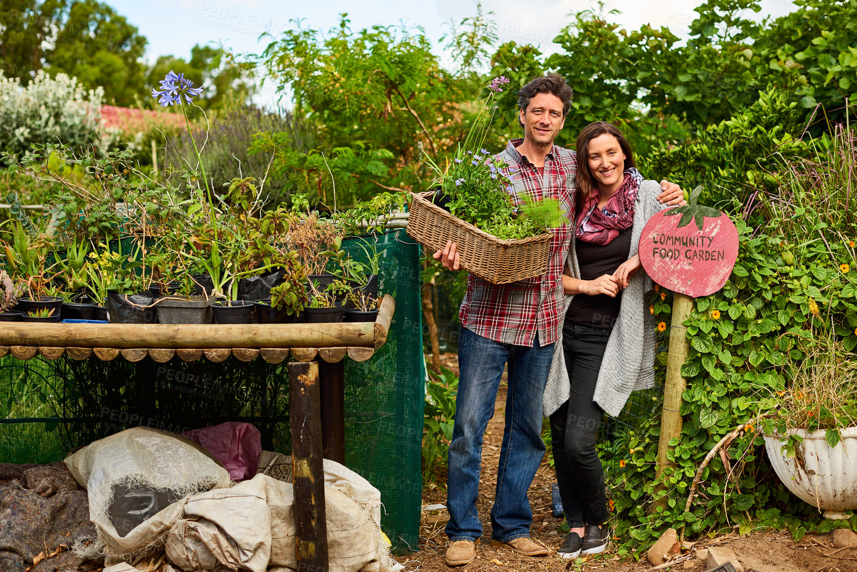 Buy stock photo Portrait of a smiling couple standing in their organic garden