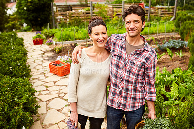 Buy stock photo Portrait of a smiling couple standing in their organic garden