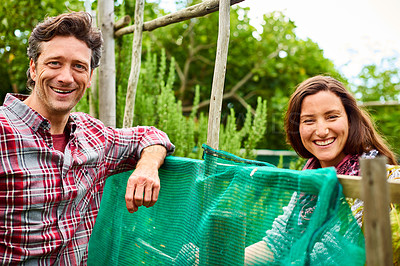 Buy stock photo Portrait of a smiling couple standing in their organic garden
