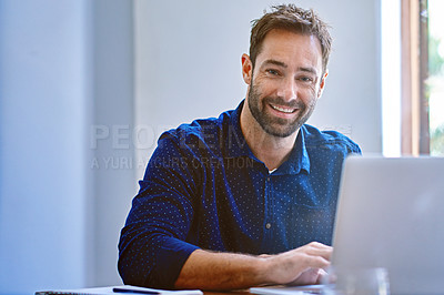 Buy stock photo Portrait of a smiling man sitting at a desk in an office working on a laptop