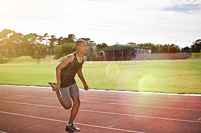Buy stock photo Shot of a young athlete out running on the track