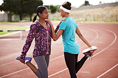 Buy stock photo Cropped shot of two young athletes out on the track