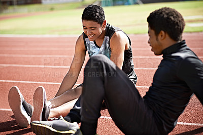 Buy stock photo Shot of young athletes sitting together on the track