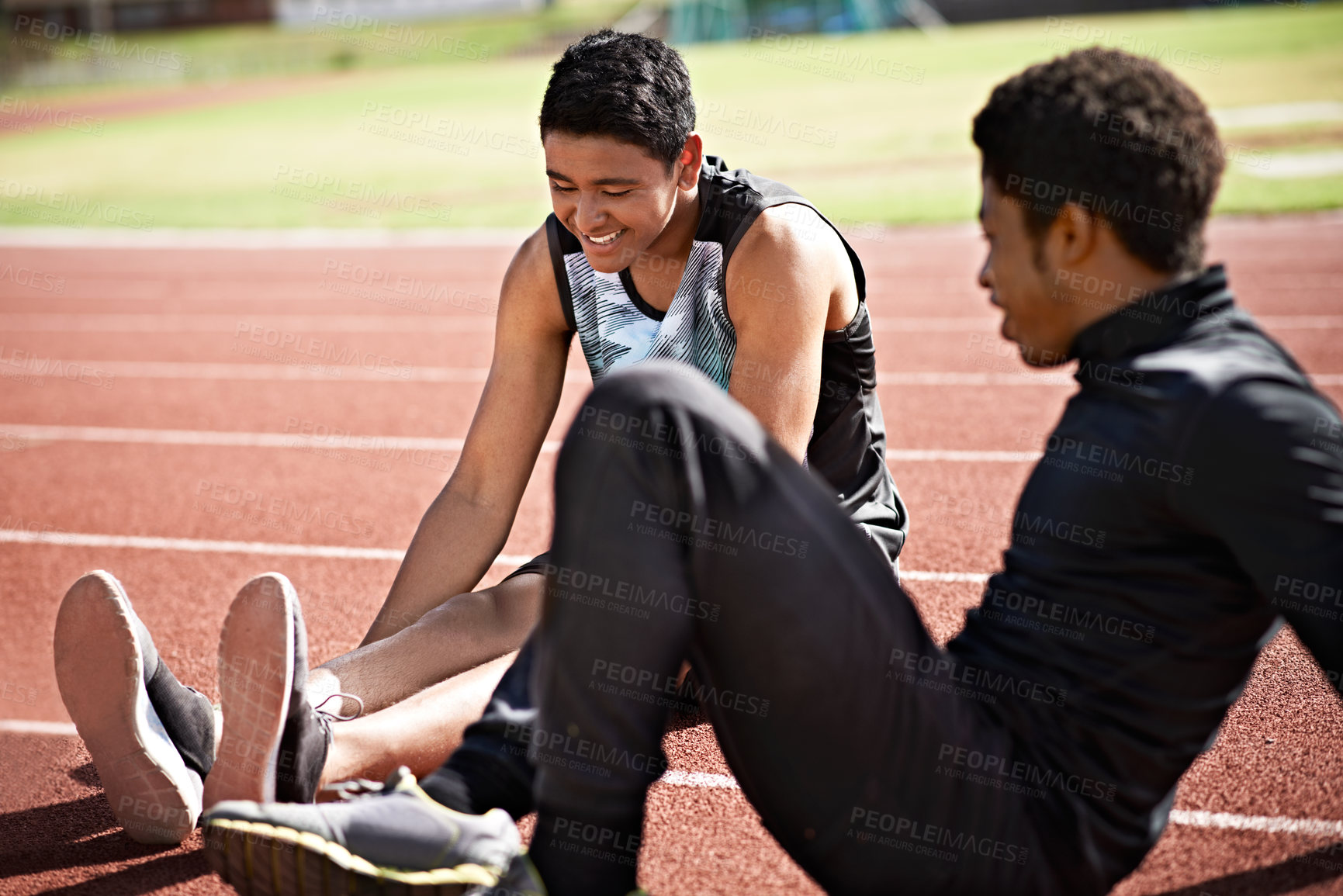 Buy stock photo Shot of young athletes sitting together on the track