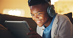 Headphones, tablet and black child in home at night with elearning, gaming or online development. Relax, happy and boy with digital technology for game on app for growth or education in living room.