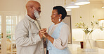 Dancing, happy and black couple in kitchen at house with music for bonding, love and connection together. Smile, marriage and mature man with woman for moving to romantic playlist on weekend in house