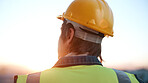 Thinking, man and engineer outdoor for construction, inspection and idea for architecture. Back, male person and helmet with reflection, building view and quality assurance for urban infrastructure