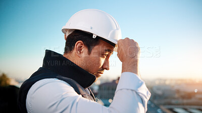 Buy stock photo Thinking, man and engineer with helmet for construction, vision and architecture in city. Male person, ppe and outdoor with reflection, building view and quality assurance for urban infrastructure