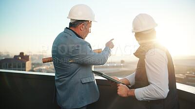Buy stock photo Architect, tablet and team pointing on rooftop for discussion, real estate development or flare. Tech, construction or men planning in city, property project or show building with sunshine from back