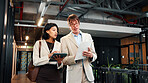 Walking, tablet and business people with documents in office for planning, agenda and finance review. Corporate, meeting and workers on tech for financial report, feedback and proposal for budget