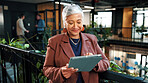 Woman, smile and tablet in office with sustainable business, ESG report and carbon footprint audit. Manager, mature person and tech with eco friendly company, environmentalist research and browsing.