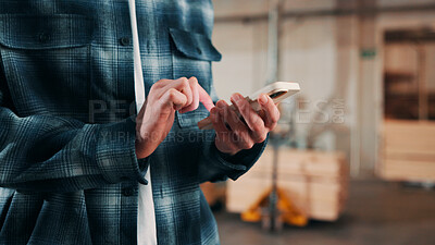 Buy stock photo Man, hands and carpenter typing with phone in workshop for online network or shipping order. Male person, carpentry or texting on mobile smartphone for business stock, wood production or distribution