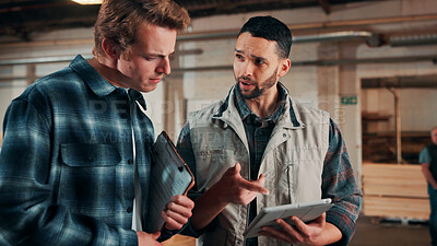 Buy stock photo Men, tablet and discussion in lumber workshop, carpenter and supplier with clipboard for timber delivery. Point, talk and people on tech for checklist, feedback and woodworking inventory management