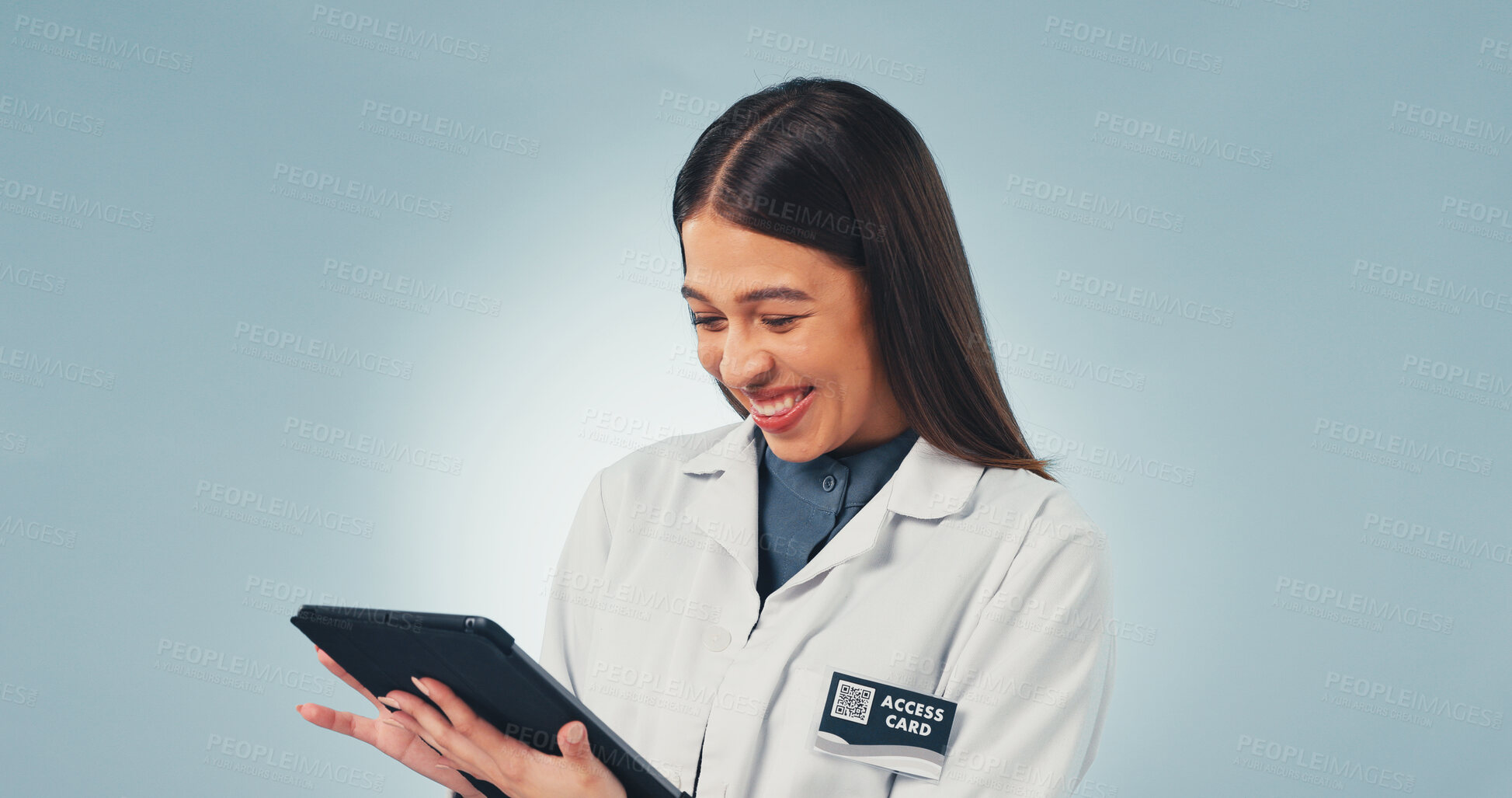 Buy stock photo Happy, woman and scientist in studio with tablet for medical research, innovation or pharmaceutical report. Space, biologist and reading on tech for science study and healthcare on blue background.