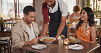 Waiter, serving and couple in restaurant for date, connection or bonding on weekend together. Happy, food and server with man and woman for dinner, meal or supper order on anniversary in diner.