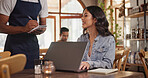 Laptop, order and waiter with woman in restaurant for menu option, freelancer and lunch break. Smile, cafe and remote worker with customer in coffee shop for drinks request, hospitality and tech