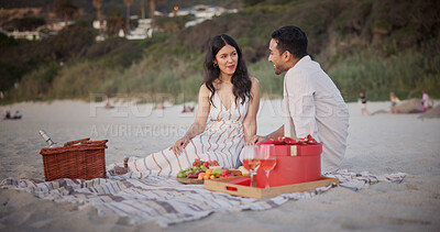 Buy stock photo Love, celebration or couple at beach with picnic, holiday together or bonding on romantic anniversary. Happy, honeymoon or people with fruit, partner connection or special moment on outdoor getaway.