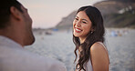 Love, woman and couple at beach with smile, romantic moment and bonding together on summer holiday. Care, trip and people with security, partner connection and happy relationship on outdoor date.