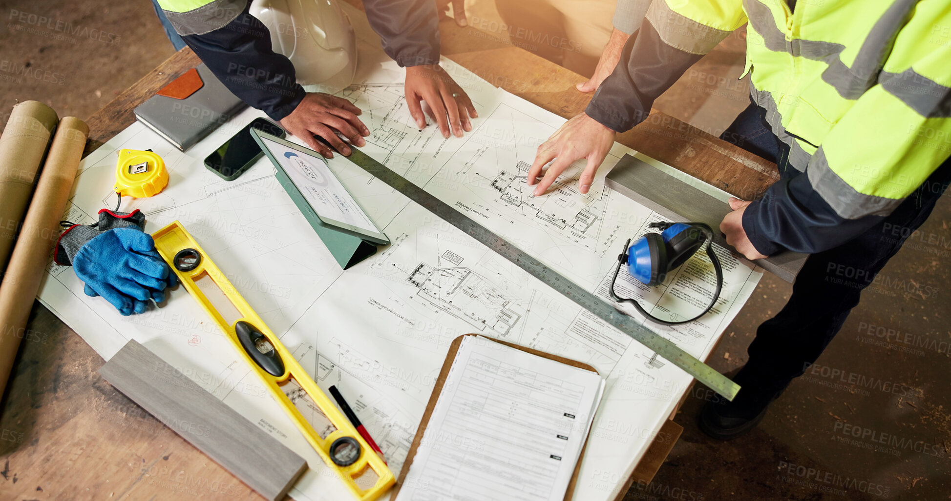 Buy stock photo Hands, team and blueprint at worksite for architecture, project management and design evaluation. Above, engineer people and floorplan with tech for remodeling process, collaboration or brainstorming