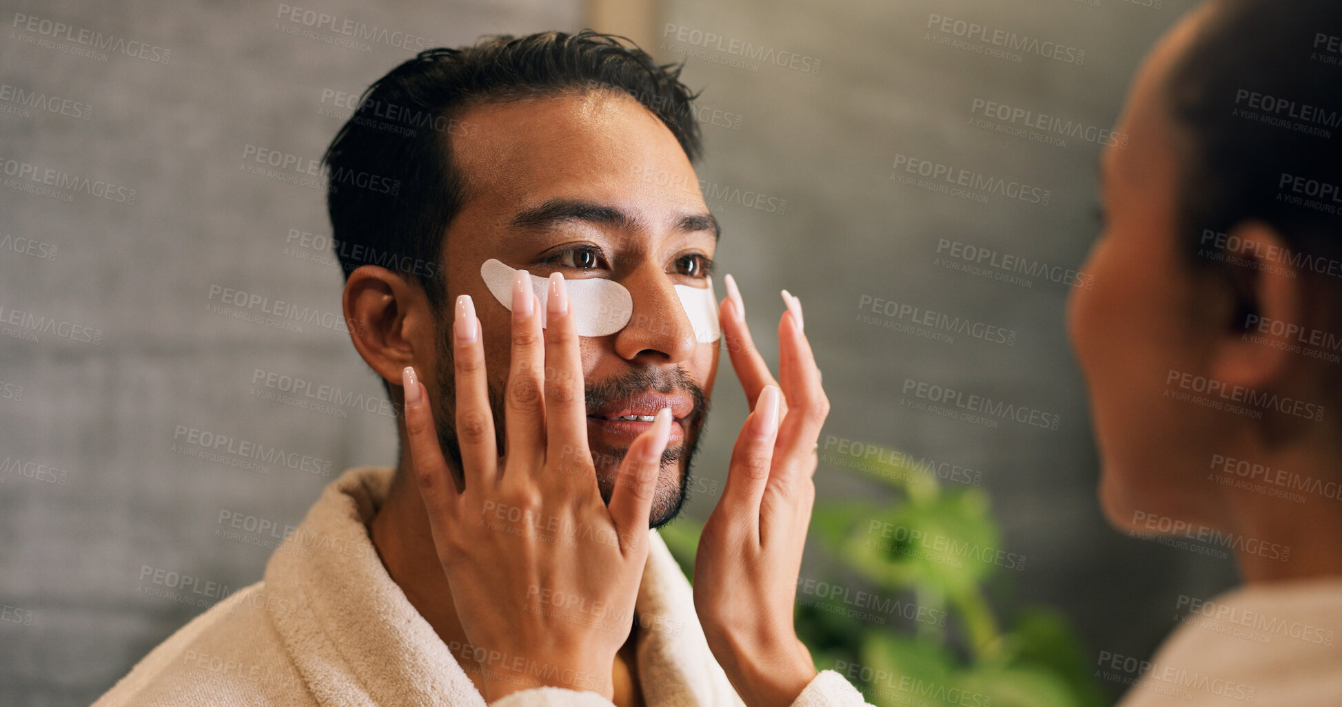 Buy stock photo Couple, skincare and eye mask application in bathroom for self care, dermatology or reduce dark circles. People, dating and apply collagen patch in home for clear skin, cosmetics or bonding together.