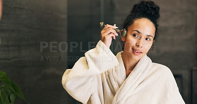 Buy stock photo Woman, skincare and jade roller in bathroom with mirror, lymphatic drainage and beauty cosmetics. Space, person and product in home with facial massage, reflection and blood circulation benefits.