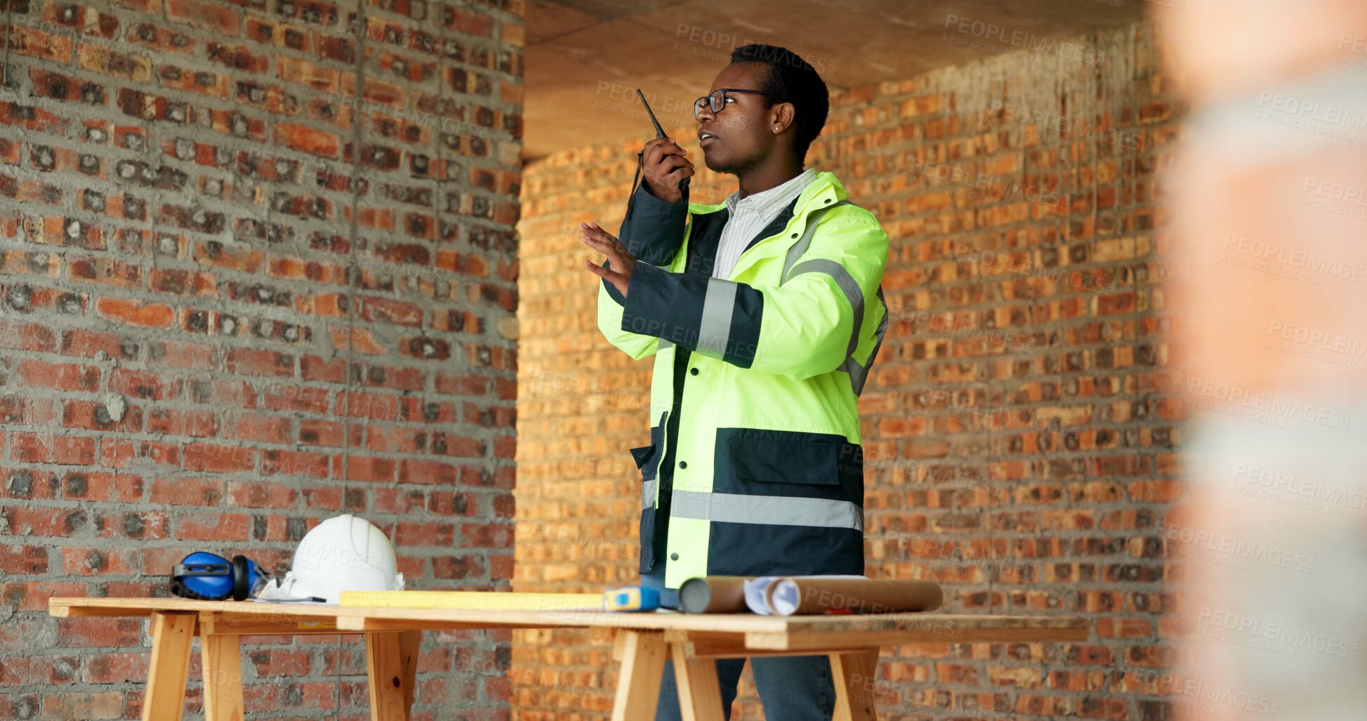 Buy stock photo Construction, man or talk with radio on site for building inspection, hazard reporting or workflow. Project manager, black person or communication for quality control, safety compliance and feedback