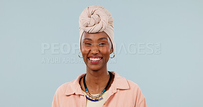 Buy stock photo Portrait, black woman and smile in studio with fashion, traditional and stylish turban for culture. Mockup space, person and laughing with headwear, handmade necklace and heritage on blue background