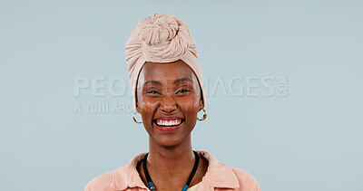 Buy stock photo Portrait, black woman and laugh in studio with fashion, traditional and stylish turban for culture. Mockup space, person and humor with headwear, handmade necklace and heritage on blue background