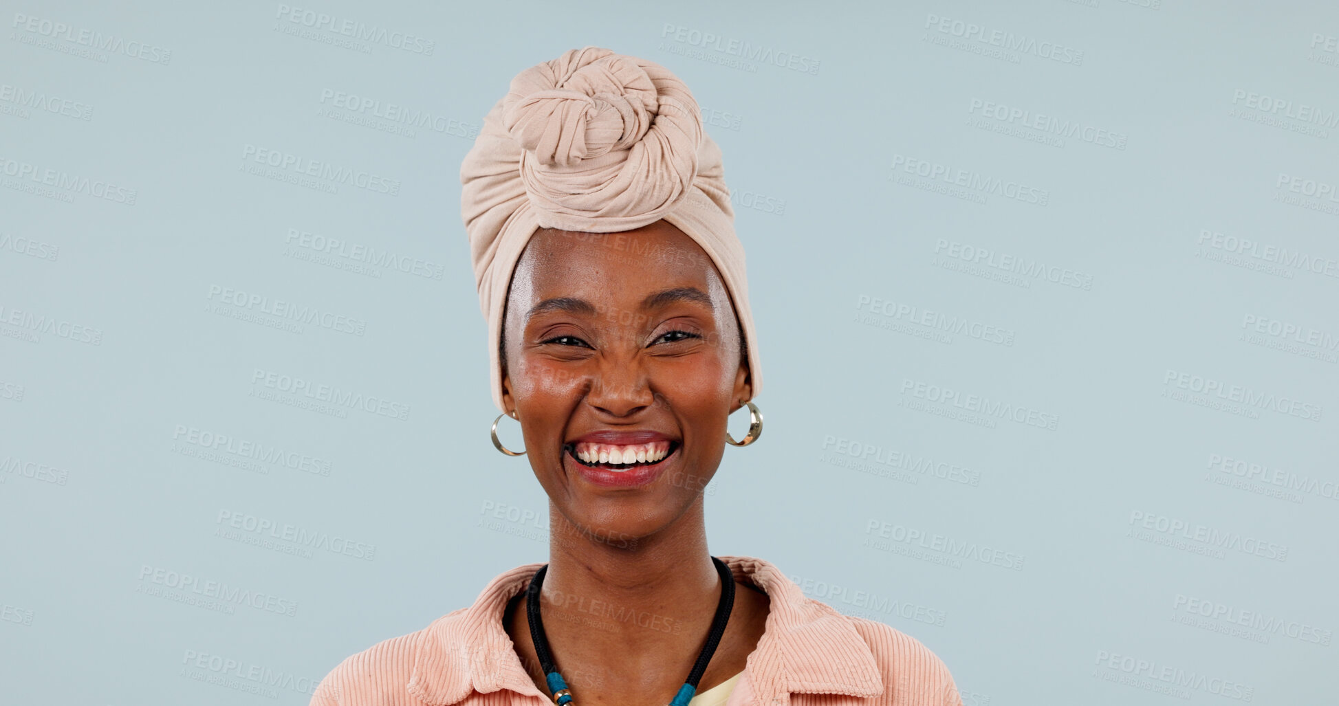 Buy stock photo Portrait, black woman and laugh in studio with fashion, traditional and stylish turban for culture. Mockup space, person and humor with headwear, handmade necklace and heritage on blue background
