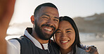 Portrait, selfie and couple hug at beach for bonding on holiday, vacation and memory together. Happy, ocean and man embrace woman with pov for social media, picture and connection for love on weekend
