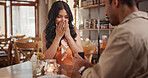 Couple, surprise and proposal in restaurant, date and relationship commitment with ring and romance. Anniversary, celebration and happy for engagement, shocked woman and bonding with man in diner