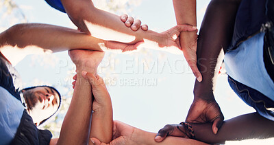 Buy stock photo Nature, group and people holding arms for support, solidarity and trust in non profit organization. Bonding, low angle and circle of volunteers with hands together for connection in ngo at park