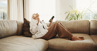 Buy stock photo Celebrate, sofa and senior woman with phone, good news and notification for online bonus in home. Retirement, happy and person with fist pump for winning, success and internet giveaway in living room